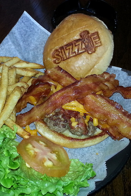 Bacon Cheese Burger with EXTRA Bacon and French fries with a bacon drizzle on top from Sizzle in Columbia South Carolina